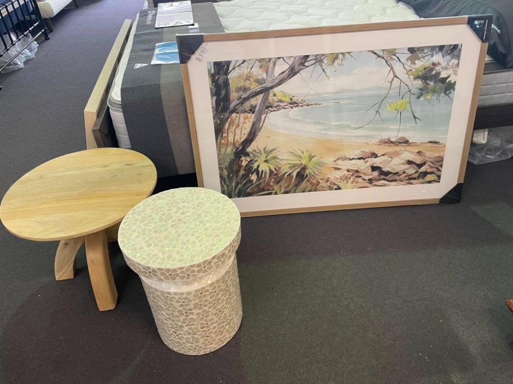 A Picture of a Beach is Hanging on a Wall Next to a Table and a Stool — P.A.M. Furnishings Pty Ltd In Yeppoon, QLD