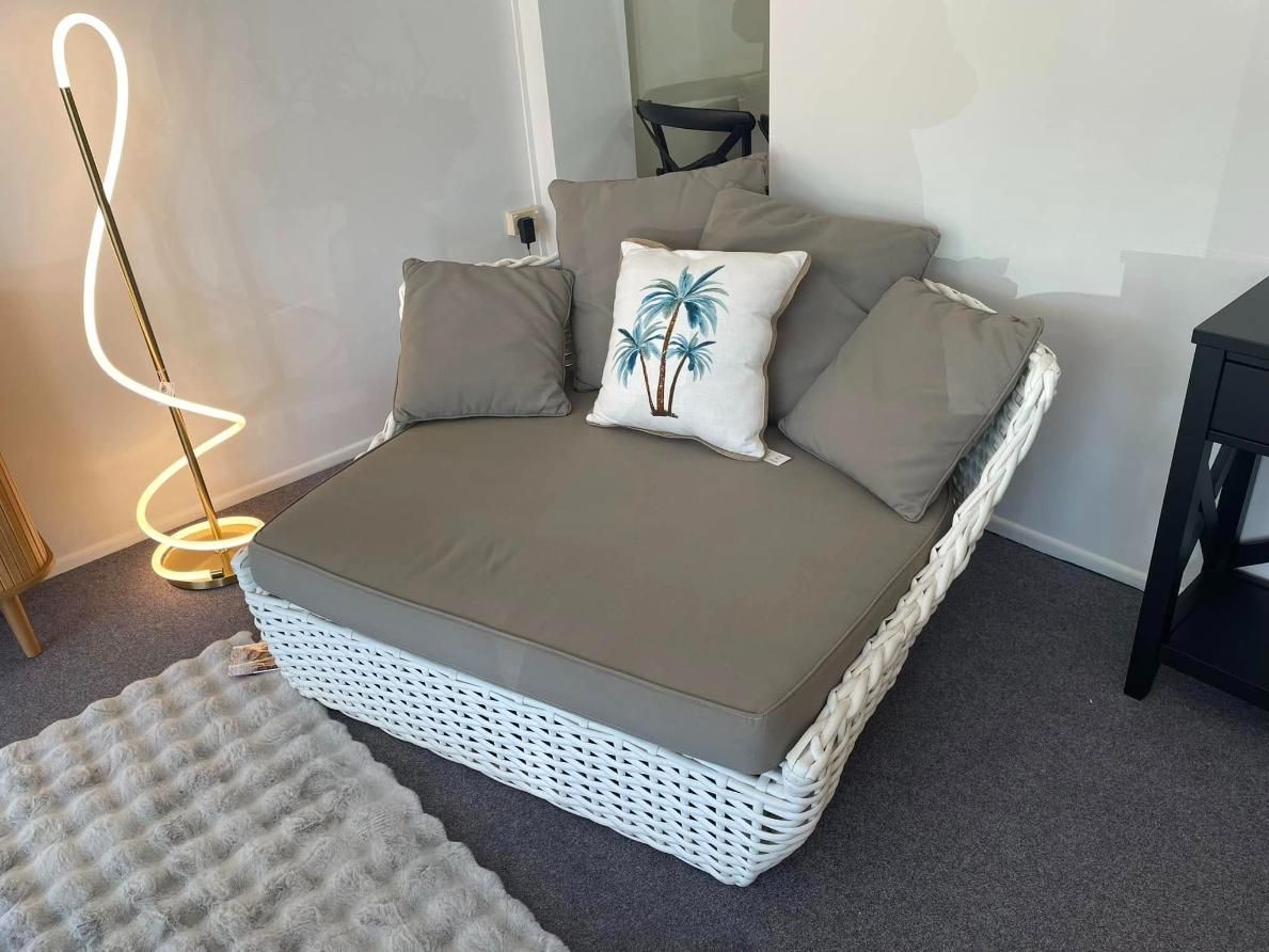 A Wicker Chair With a Pillow on It is in a Living Room — P.A.M. Furnishings Pty Ltd In Yeppoon, QLD