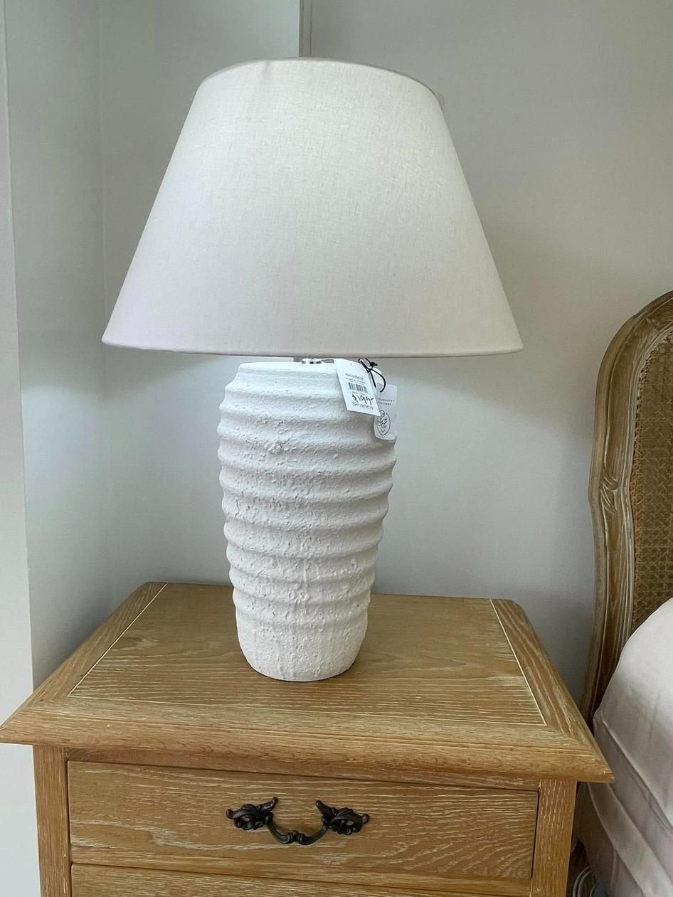 A White Lamp is Sitting on Top of a Wooden Nightstand — P.A.M. Furnishings Pty Ltd In Yeppoon, QLD