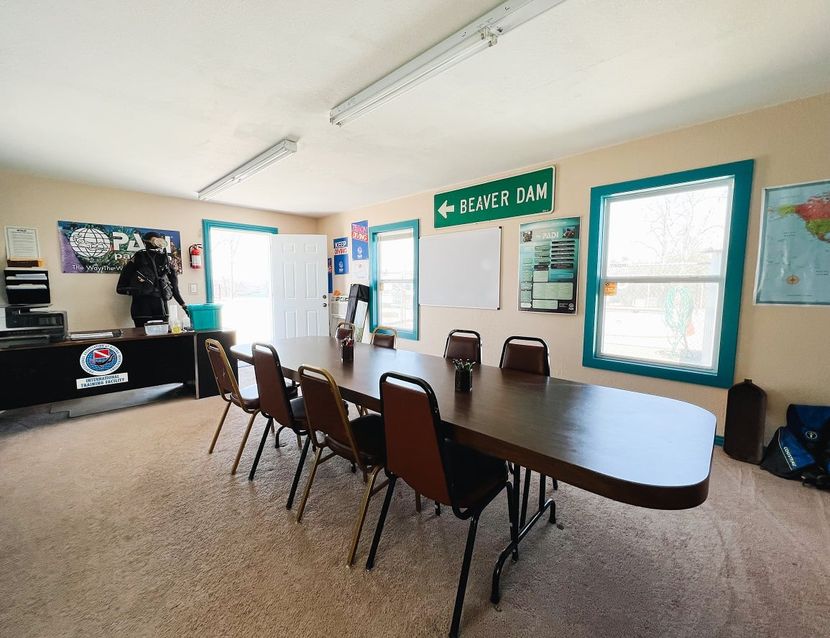 A conference room with a long table and chairs and a sign that says reception