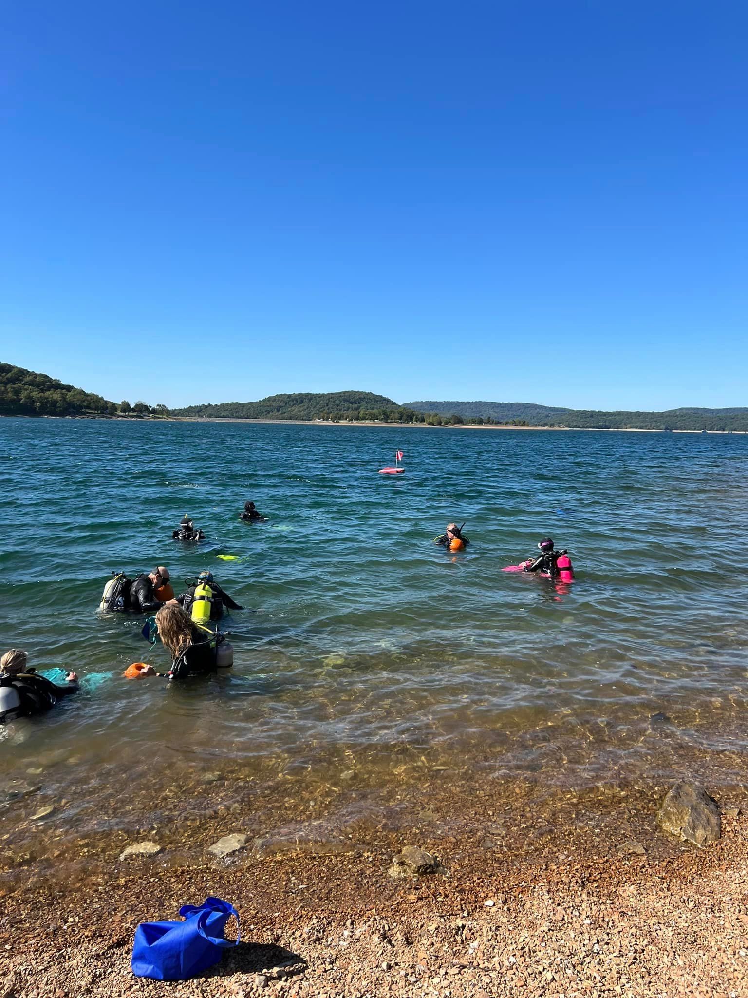 A group of people are swimming in Beaver lake.
