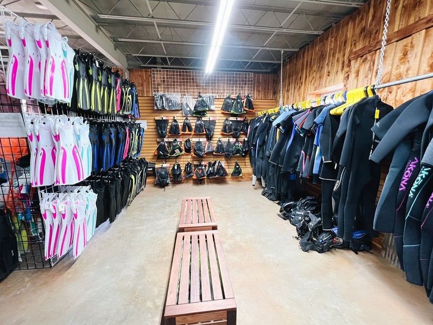 A store filled with lots of clothes and scuba gear.