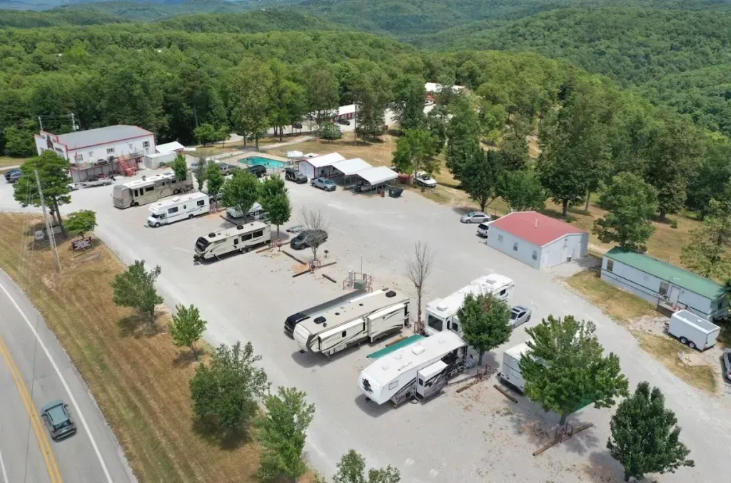An aerial view of a parking lot with a lot of rvs parked in it.