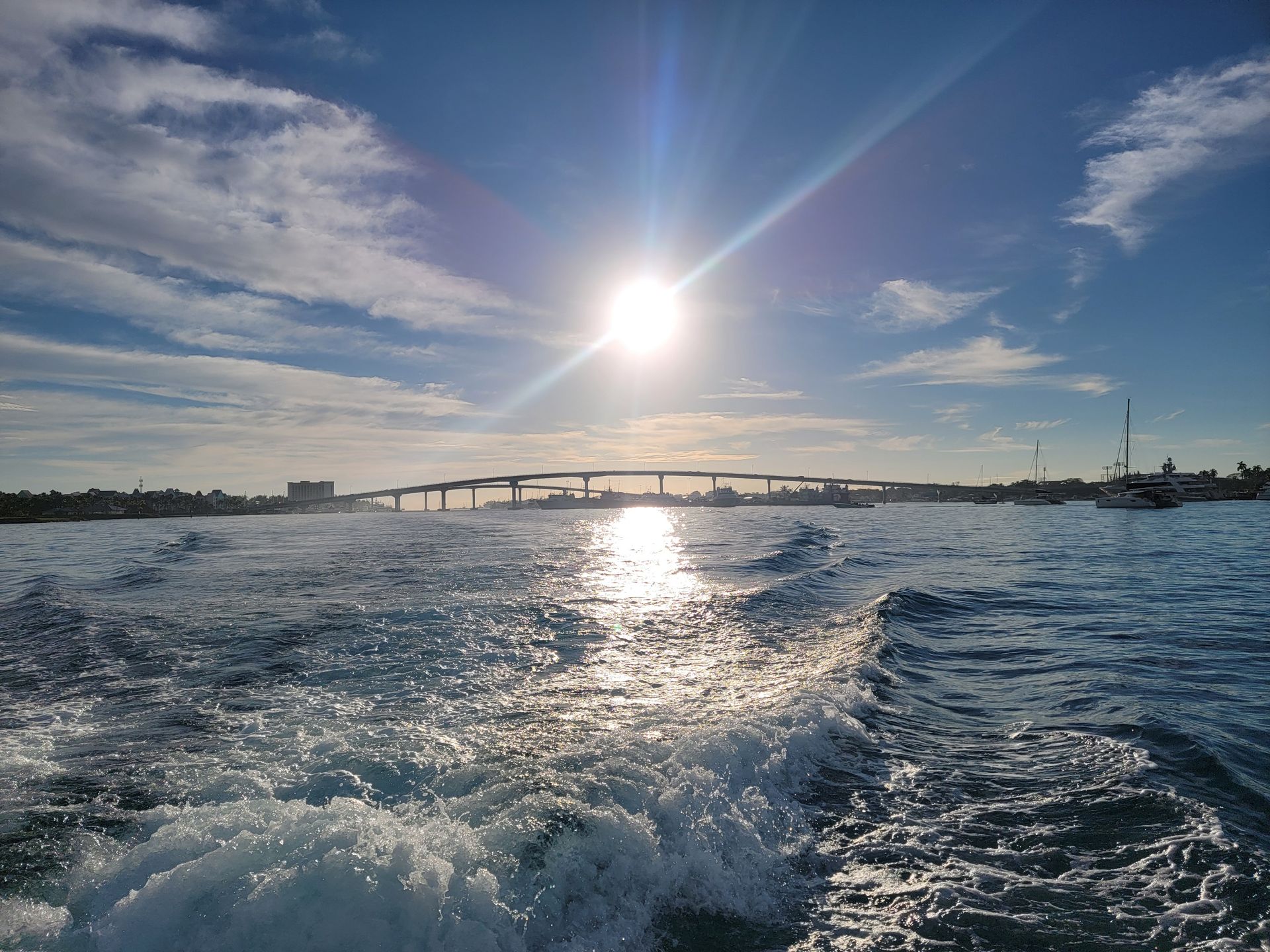 The sun is shining brightly over a body of water
