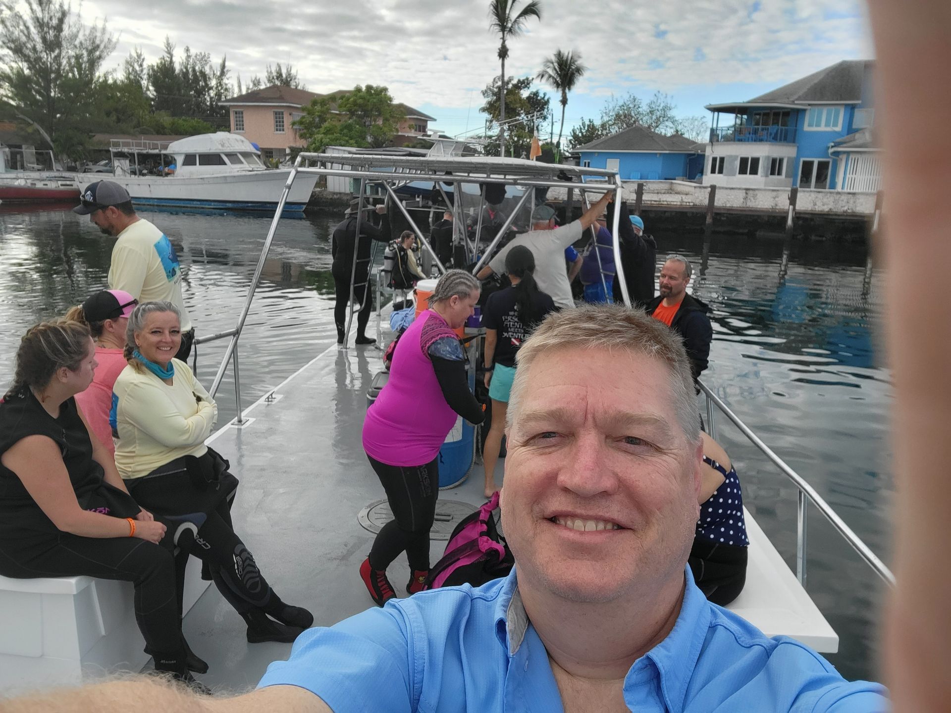 Dave in a blue shirt is taking a selfie on a boat