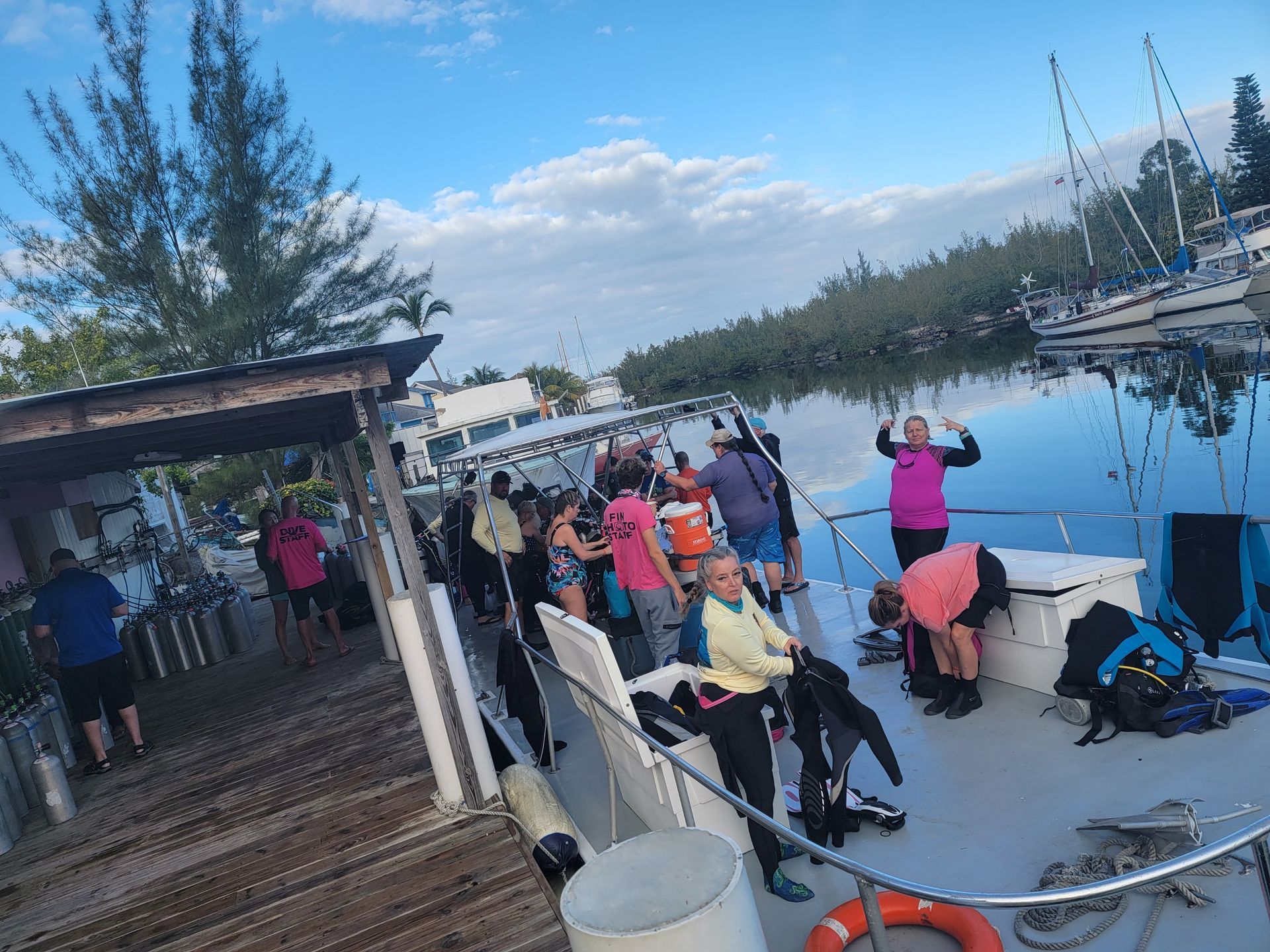 A group of people are getting ready to go scuba diving on a boat.