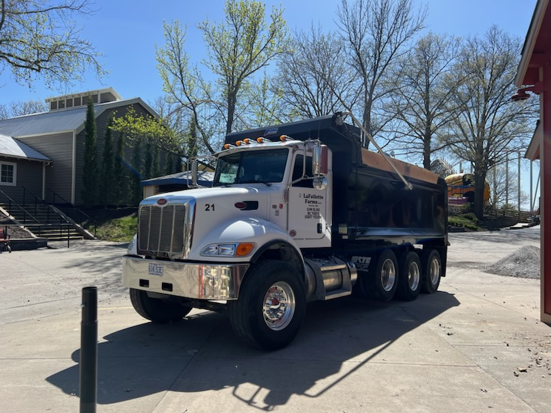 White dump truck parked on a paved area.