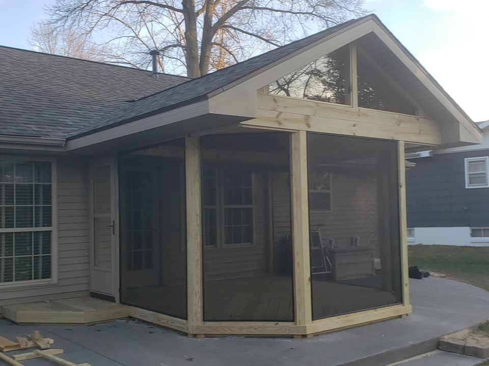 A screened in porch is being built on the side of a house in Urbana, IL.