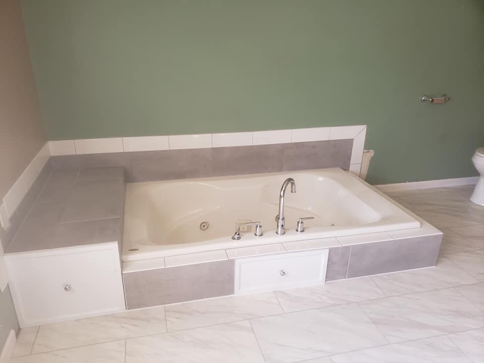 A bathroom with a jacuzzi tub and a toilet located in Danville, IL