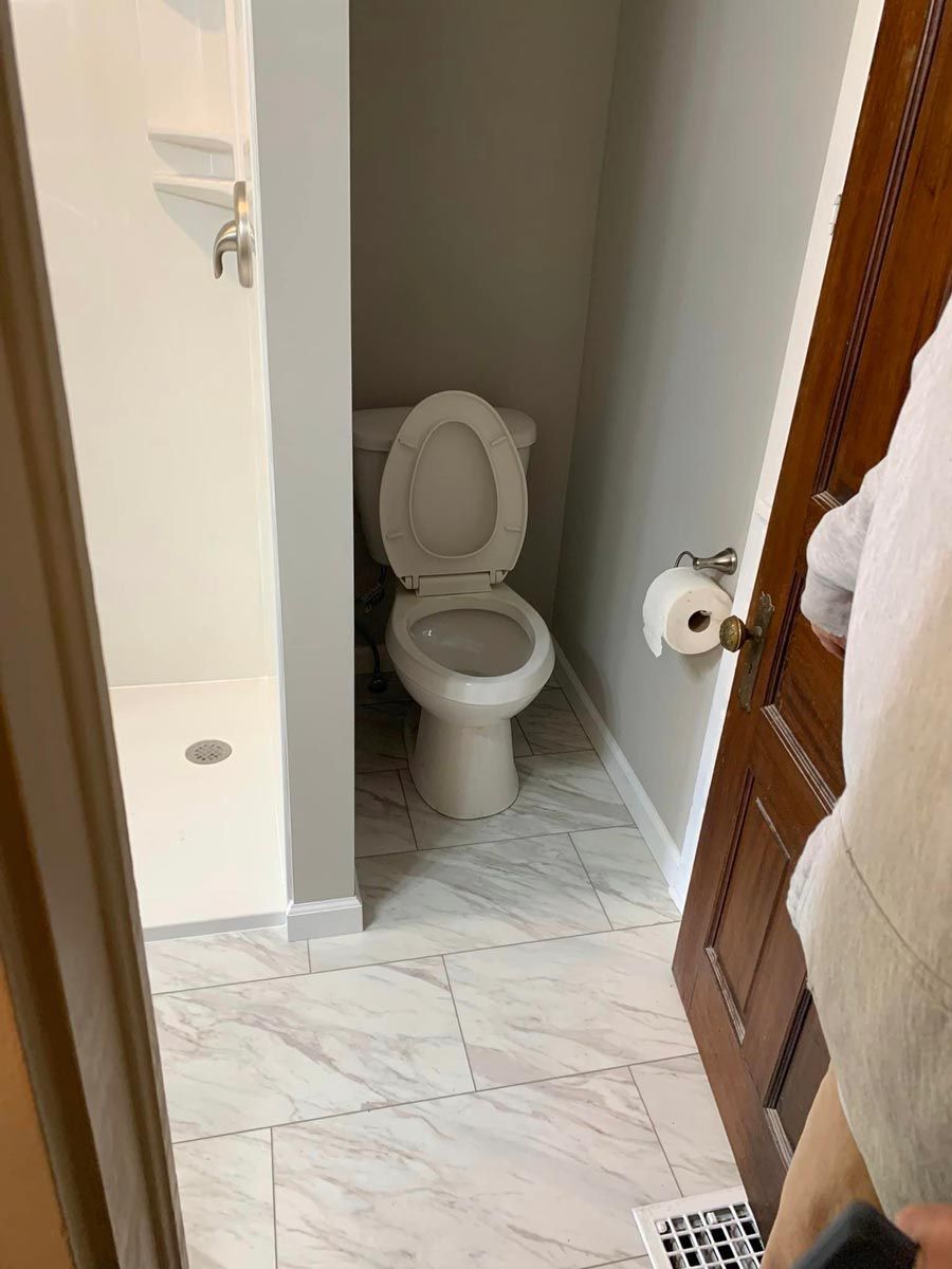 A bathroom with a toilet and a shower located in Danville, IL.