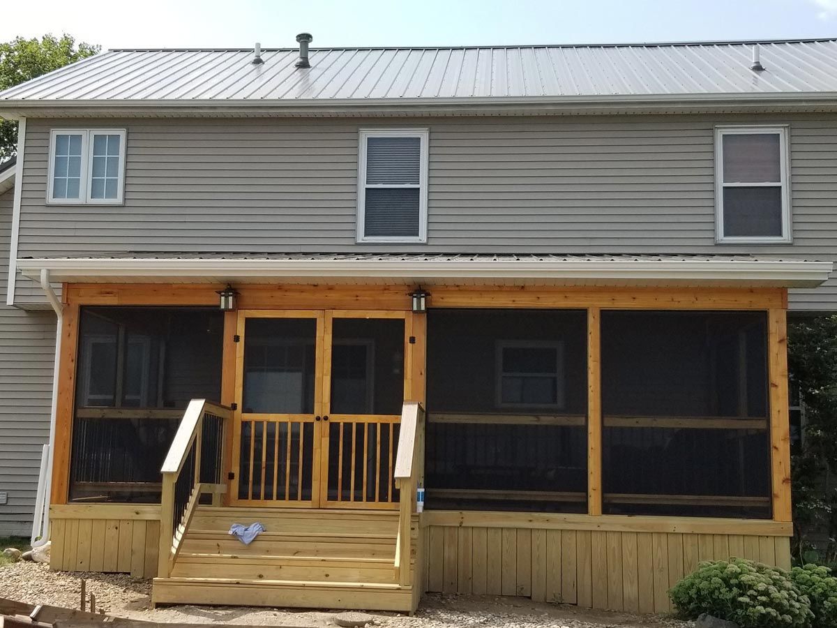 A screened in porch in front of a house located in Covington, IN.