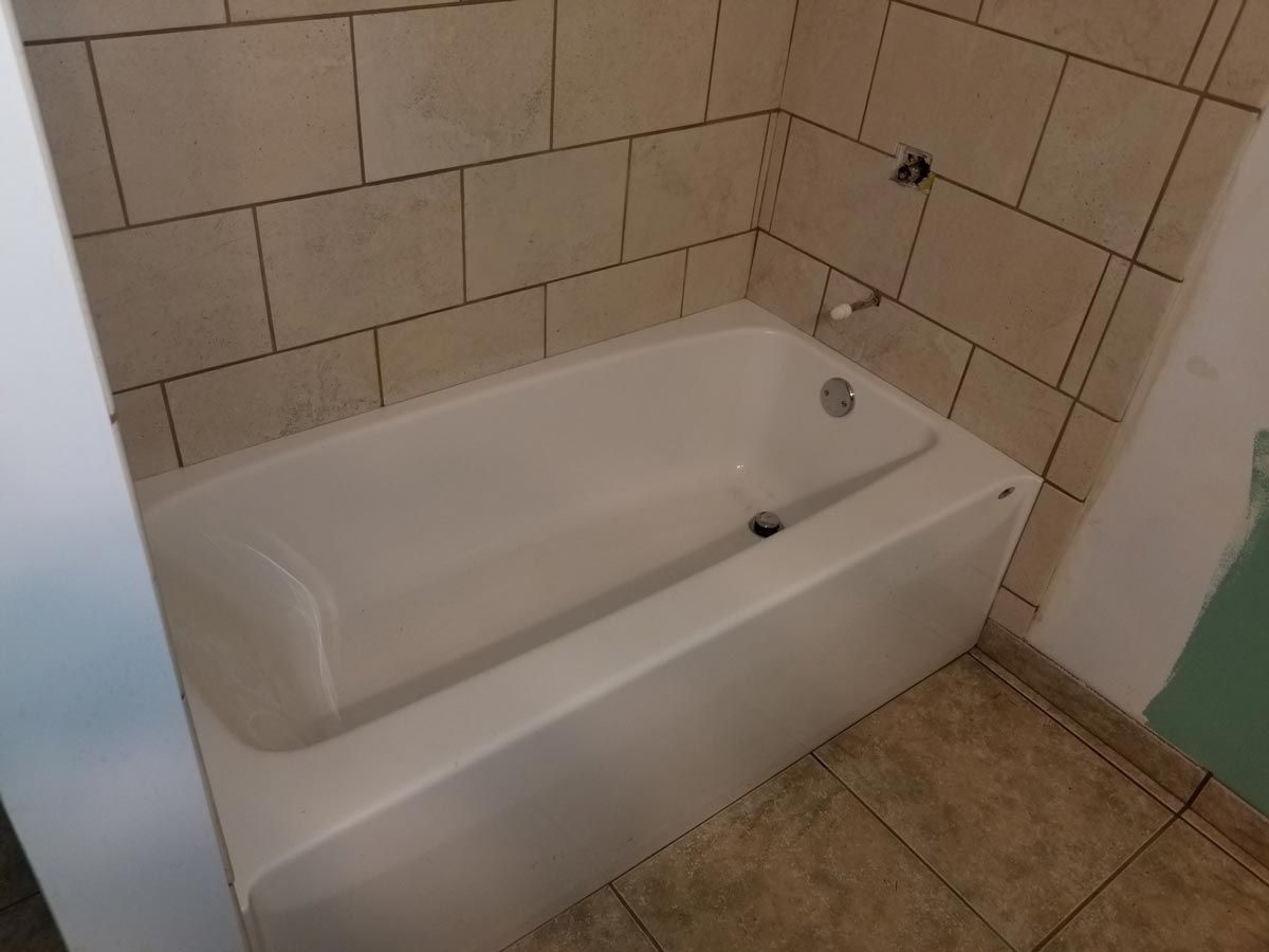 A bathtub in a bathroom with tiled walls located in Covington, IN