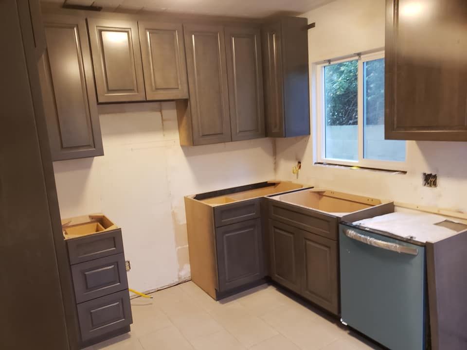 A kitchen with gray cabinets and a blue dishwasher located in Mahomet, IL.