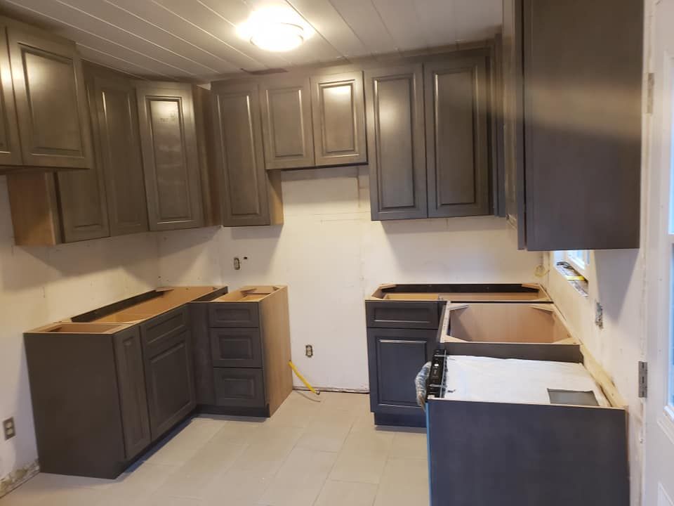 A kitchen with gray cabinets and a white stove located in Mahomet, IL