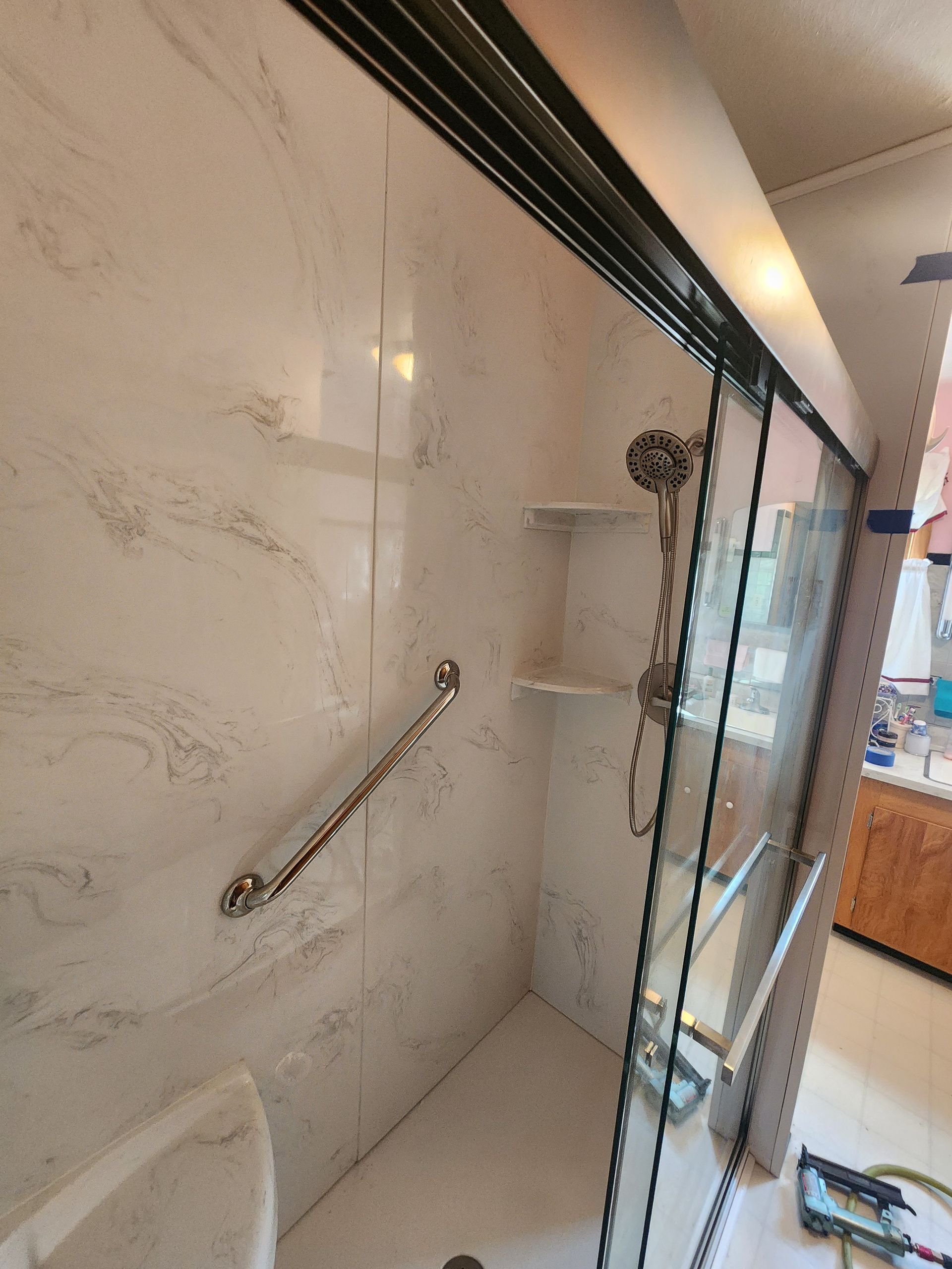 A bathroom with a toilet and a shower located in Danville, IL.