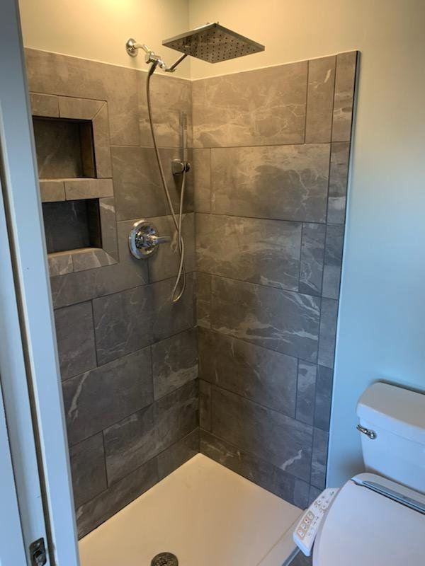 A bathroom with a walk in shower and a sink in Vermillion County, IL