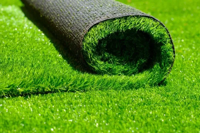 Close-up of a high-quality artificial grass roll on a lawn.