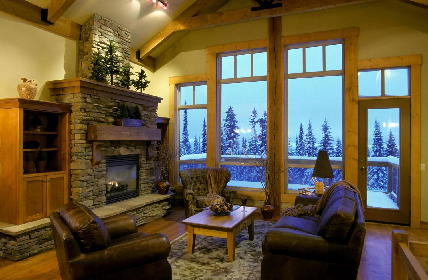 A living room with a fireplace and lots of windows