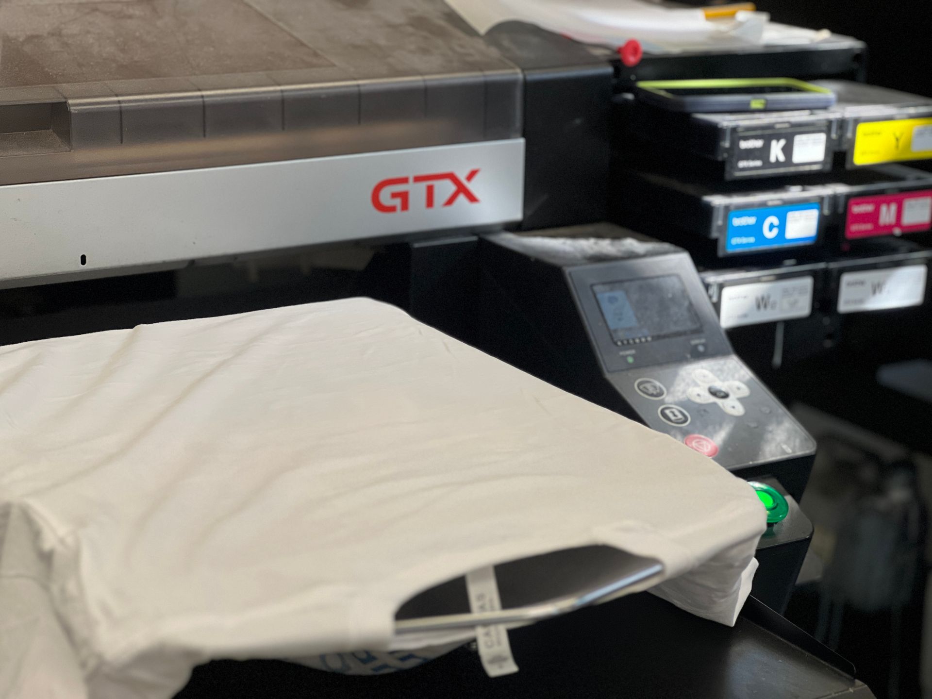 Direct to garment printer with blank white tshirt on it awaiting printed design