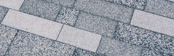 Photo of Grey floor tiles layed in a brick effect pattern