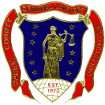 A shield with a woman holding a scale of justice on it.