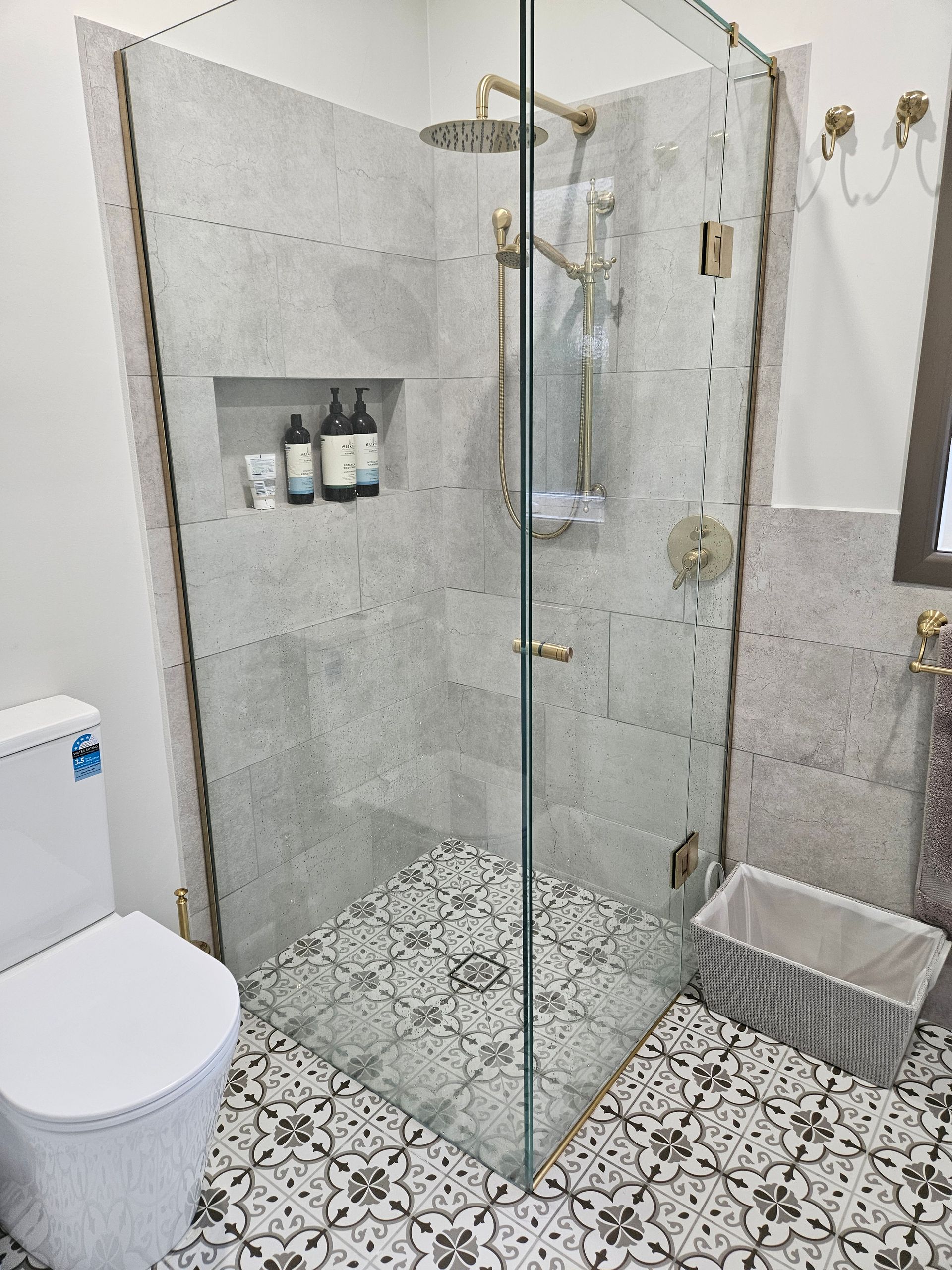 A bathroom with a walk in shower , toilet and bathtub.