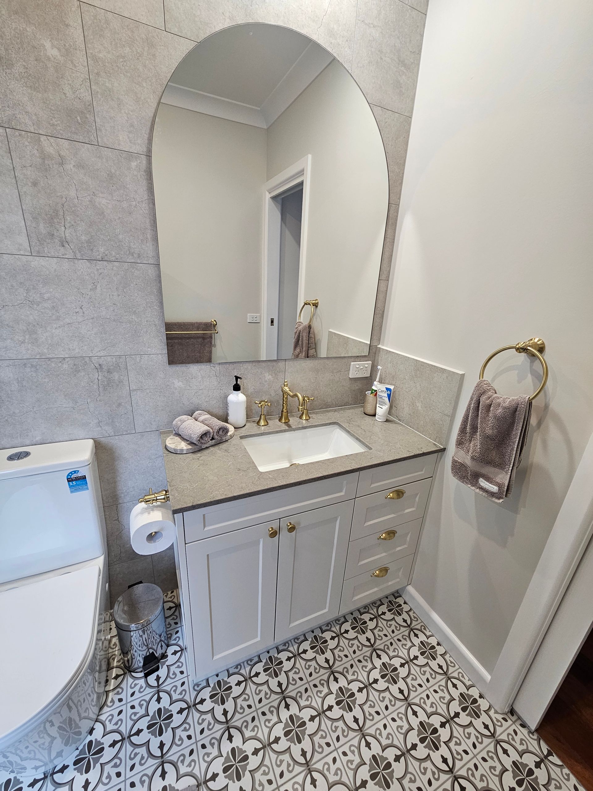 A bathroom with a sink , toilet , and mirror.