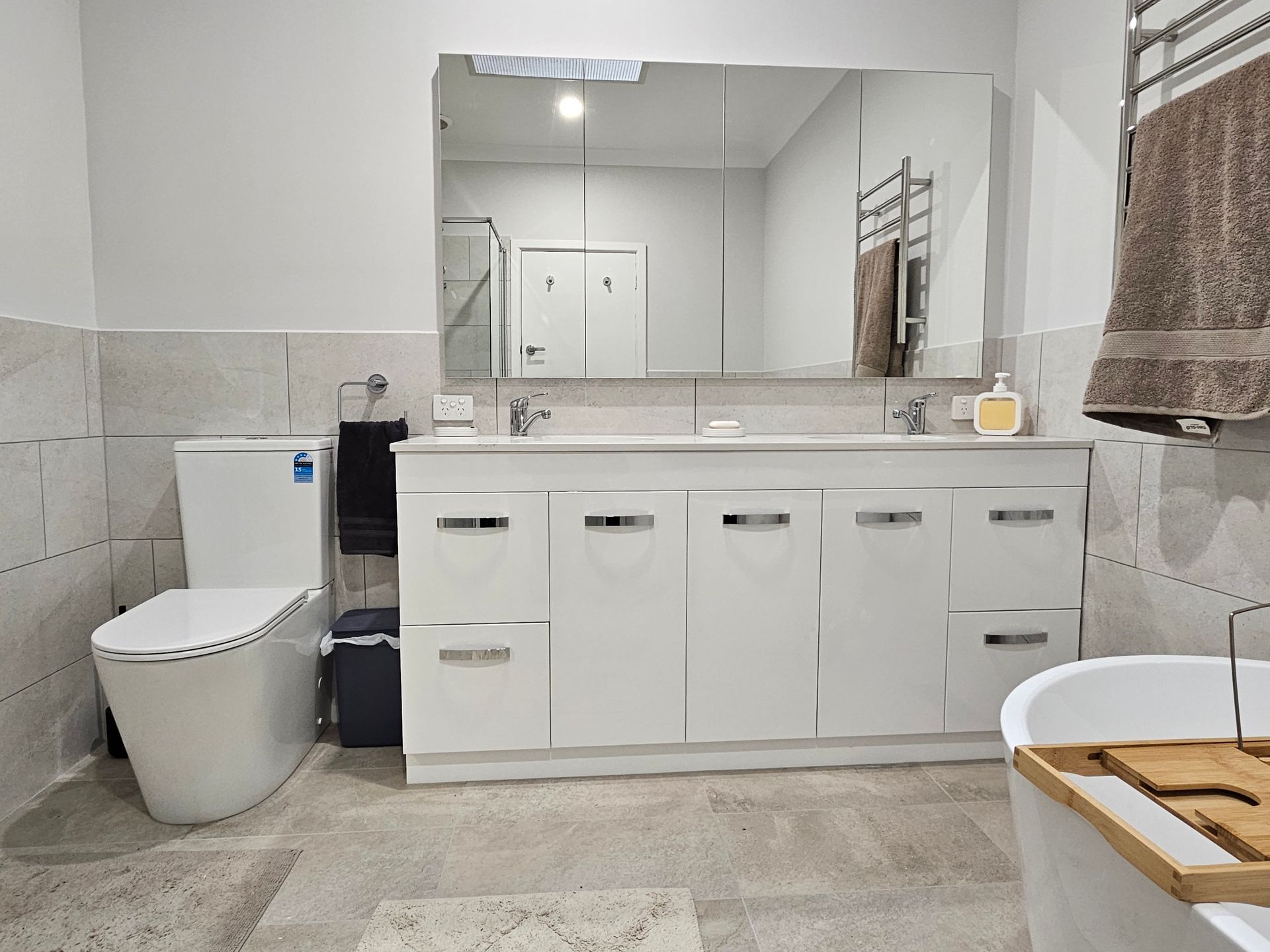 A bathroom with a toilet , sink , and bathtub.