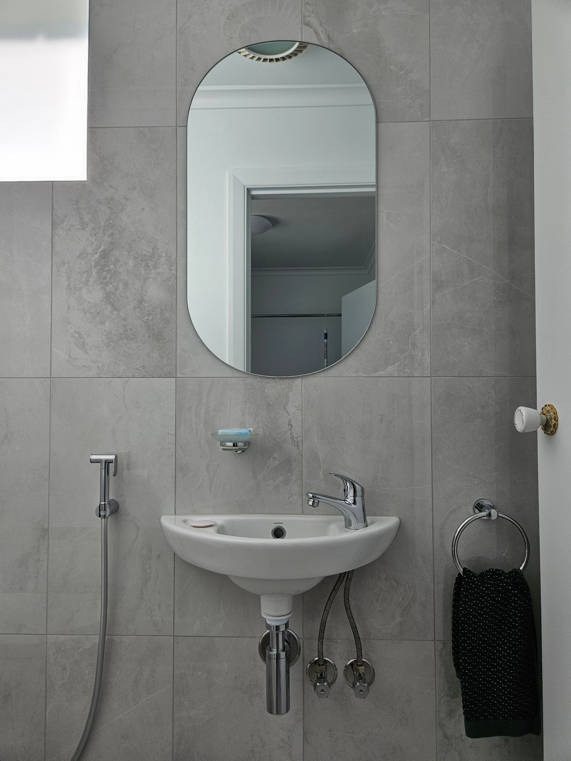 A bathroom with a sink and a mirror on the wall