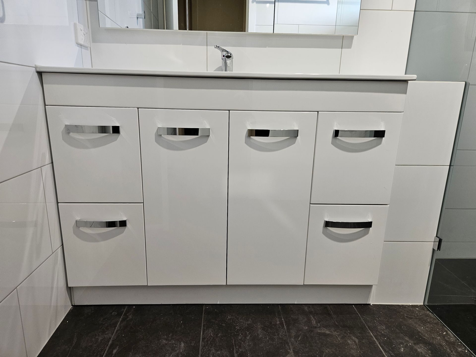 A bathroom vanity with a sink and a mirror
