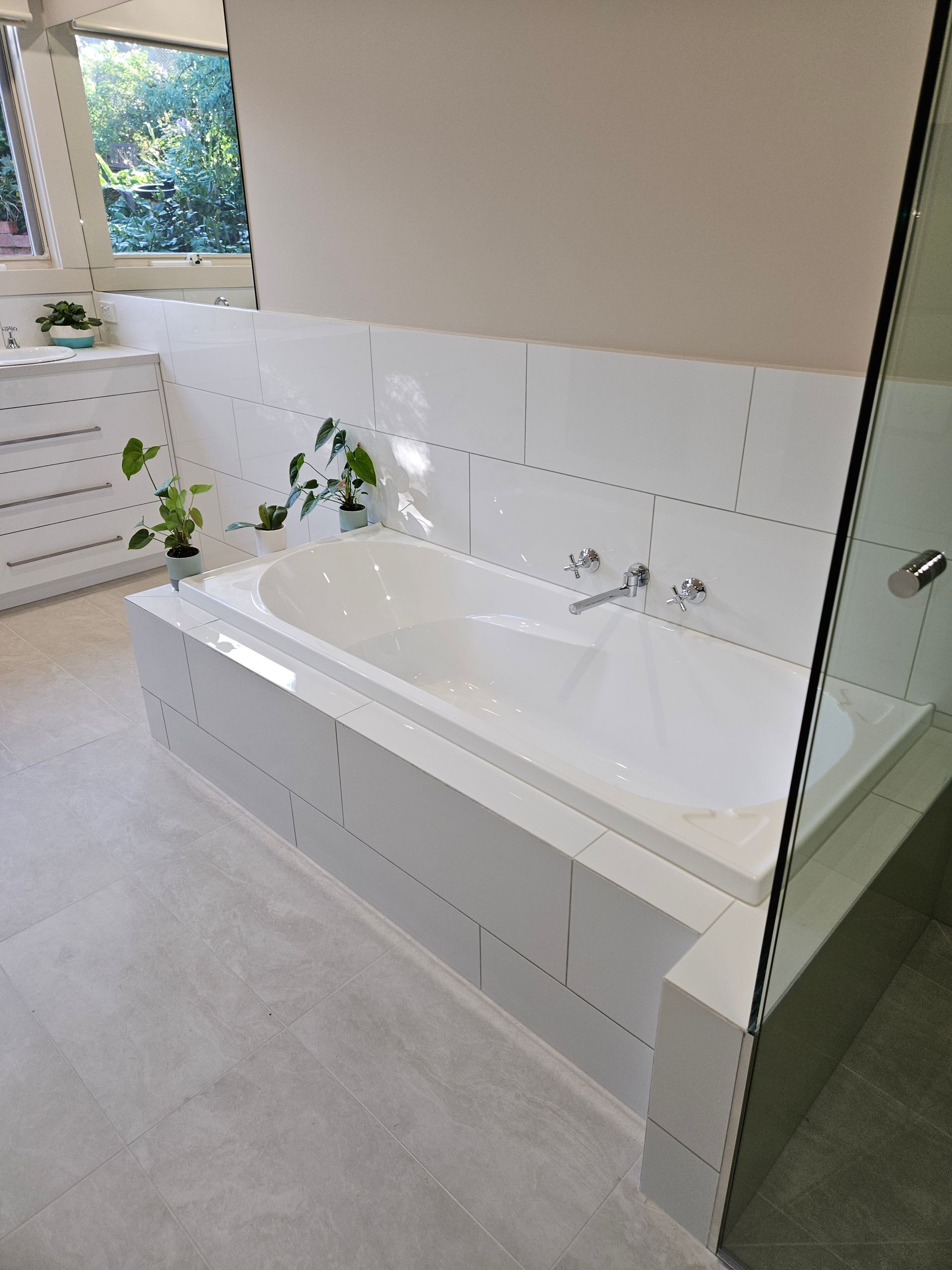 A bathroom with a bathtub and a shower.