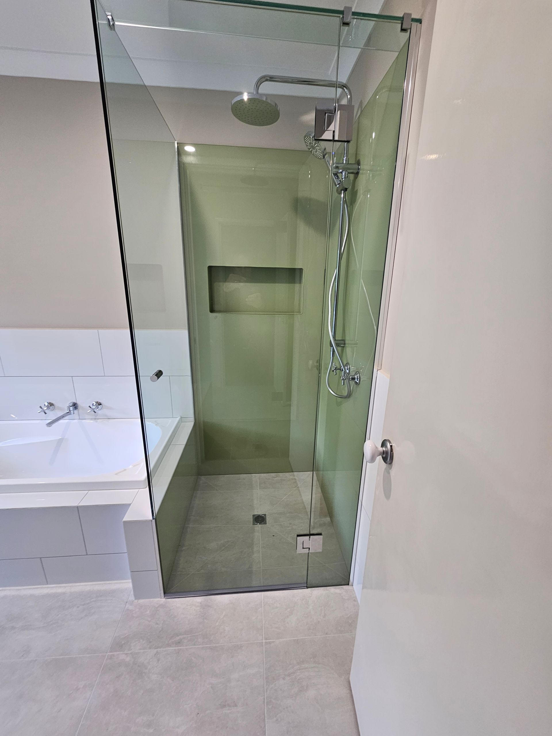 A bathroom with a walk in shower and a bathtub.