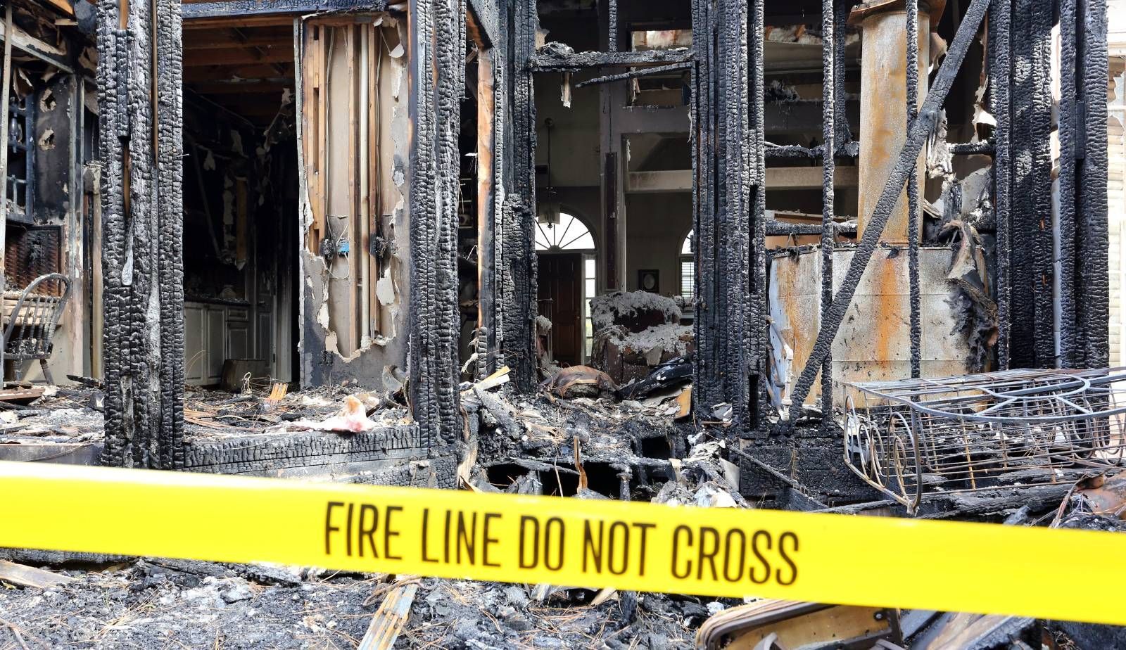 A Drymax technician carefully inspecting fire-damaged household items to salvage.