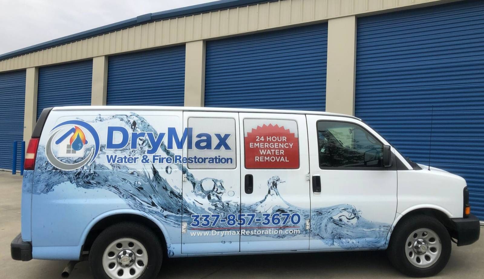 A Drymax restoration expert speaking with a homeowner about the differences between water damage coverage and flood insurance in Louisiana.