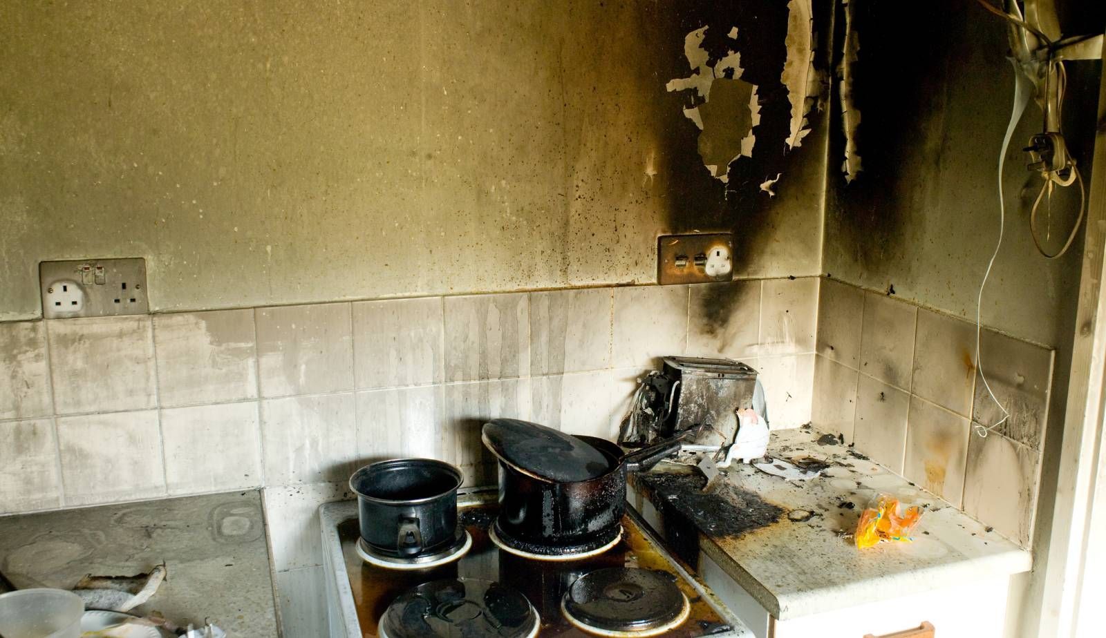 Exterior of a historic Louisiana home showing fire and smoke damage, highlighting the challenges of