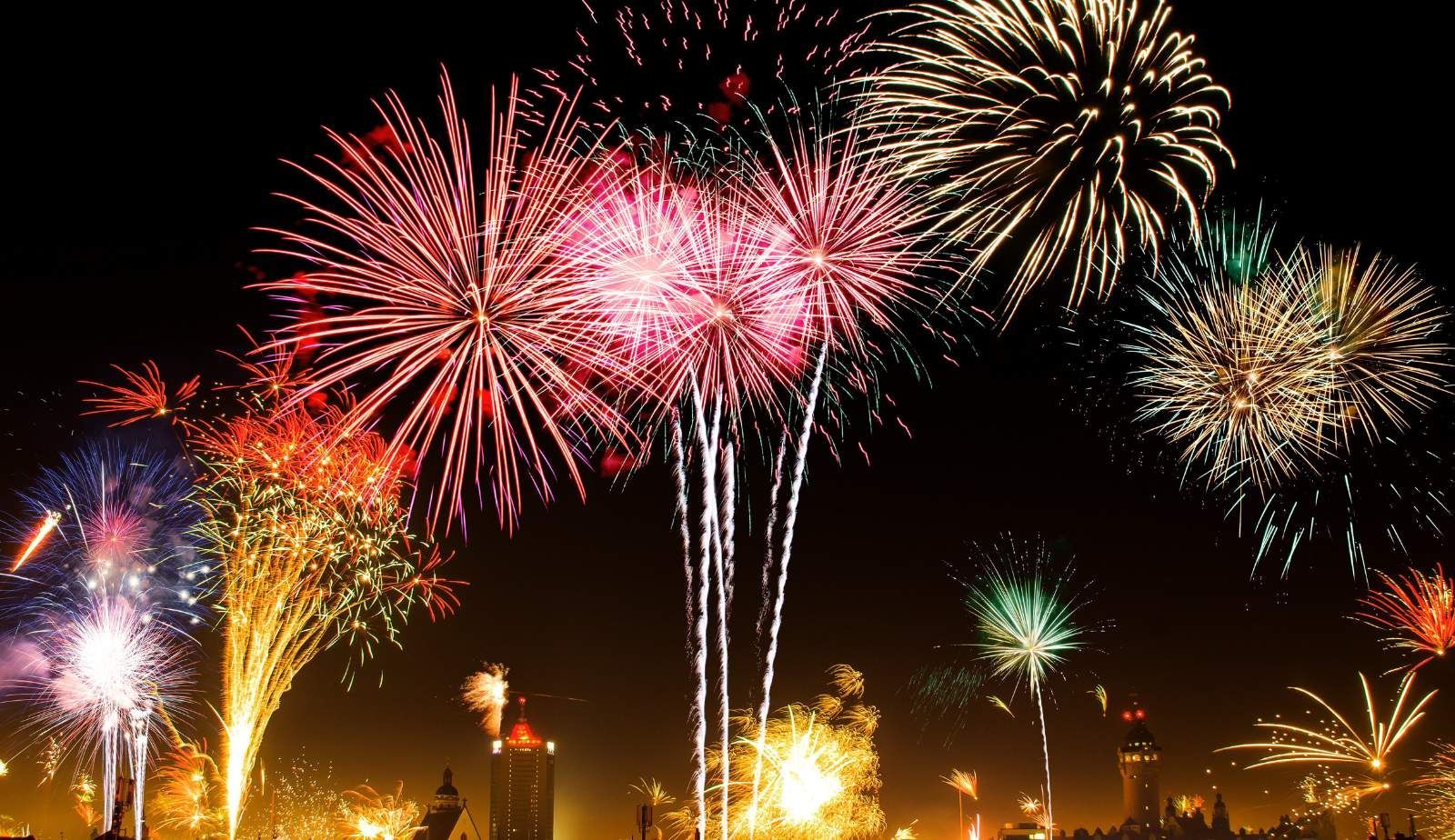 Essential safety equipment including a fire extinguisher and protective goggles laid out on a table, ready for use during a private fireworks display.