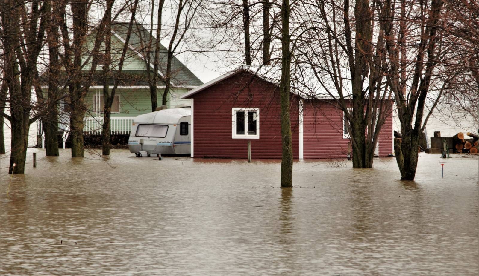 A home located in a Louisiana flood zone surrounded by rising water after heavy rain, highlighting g