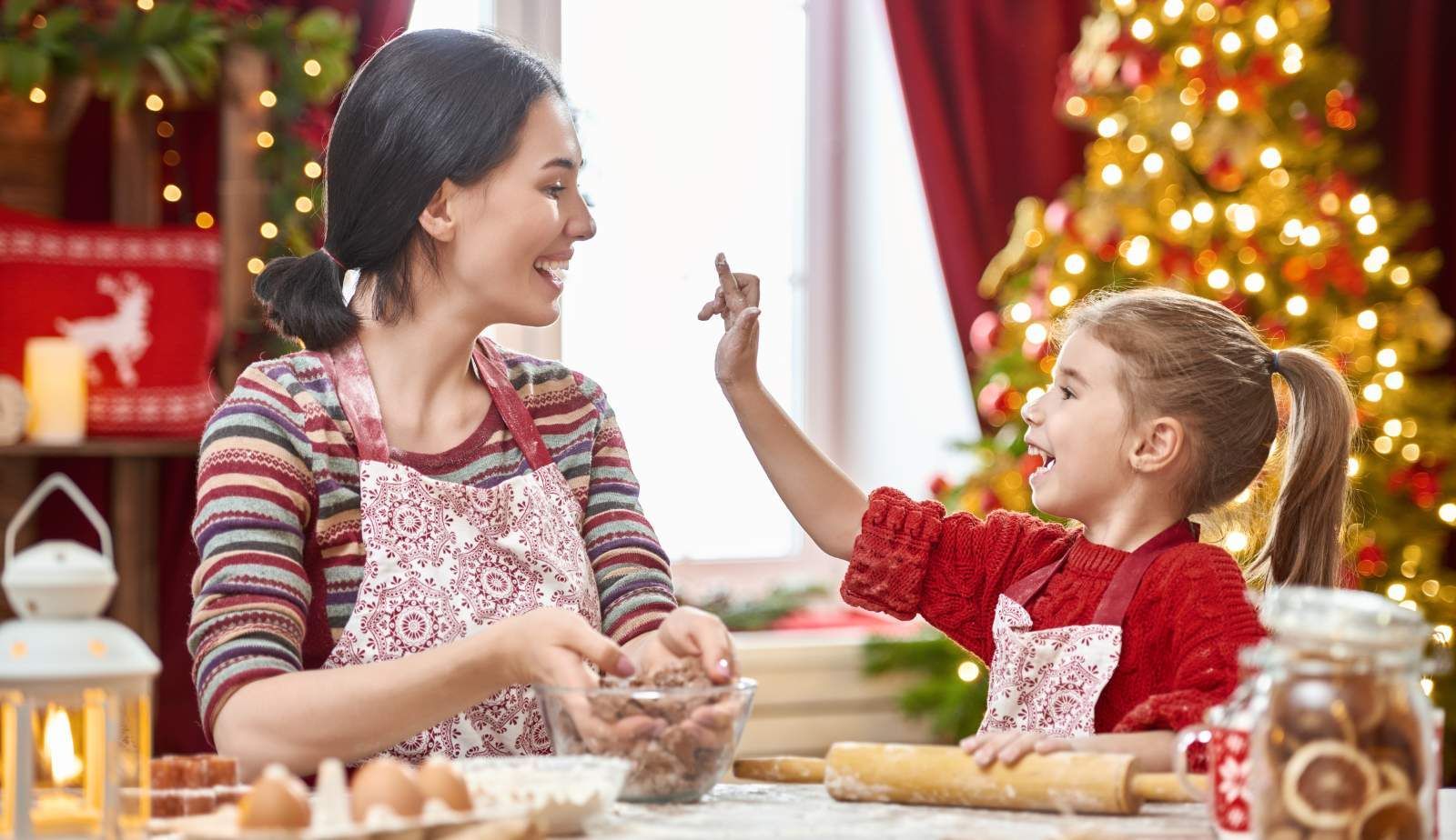 A well-organized kitchen decorated for the holidays with safety barriers around the stove.