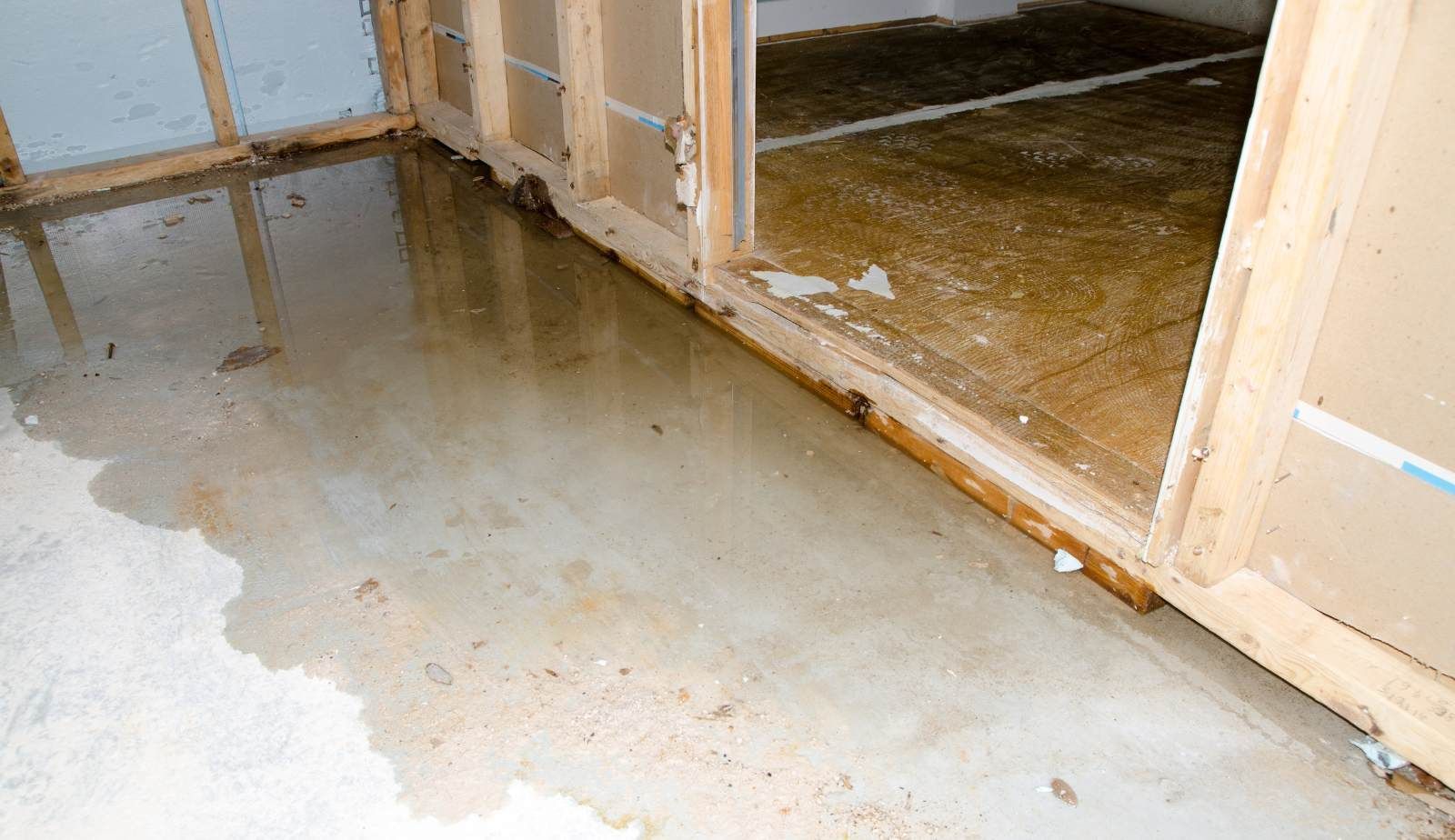Professional structural drying setup—low-grain dehumidifiers and air movers drying a wet concrete slab in Lafayette, LA by Drymax.