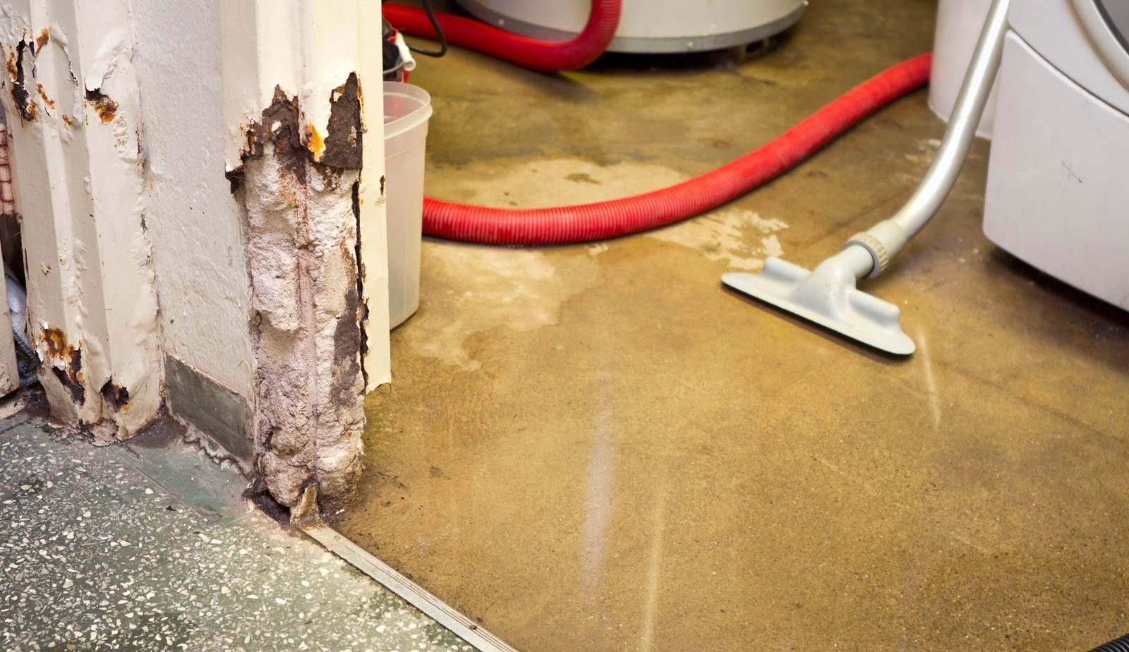 Close-up of a cracked slab foundation in a Louisiana residence, a common entry point for water and structural moisture.