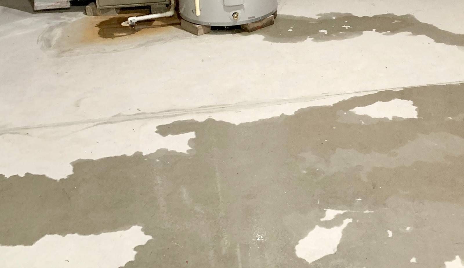 Hairline cracks in a Louisiana home’s slab foundation, a common entry point for water damage.