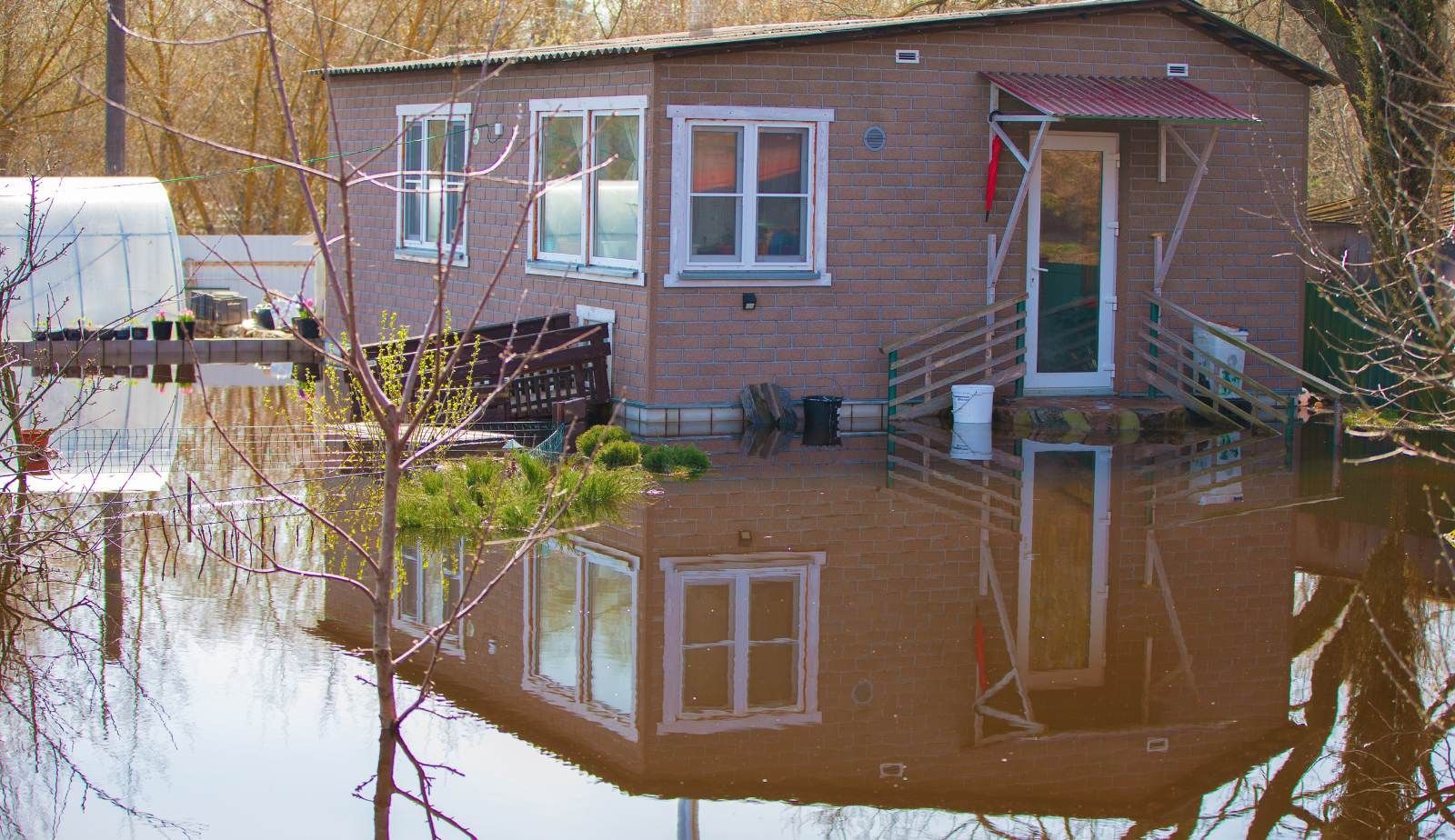 Torn vapor barrier replaced to control moisture after crawl space flooding in Baton Rouge.