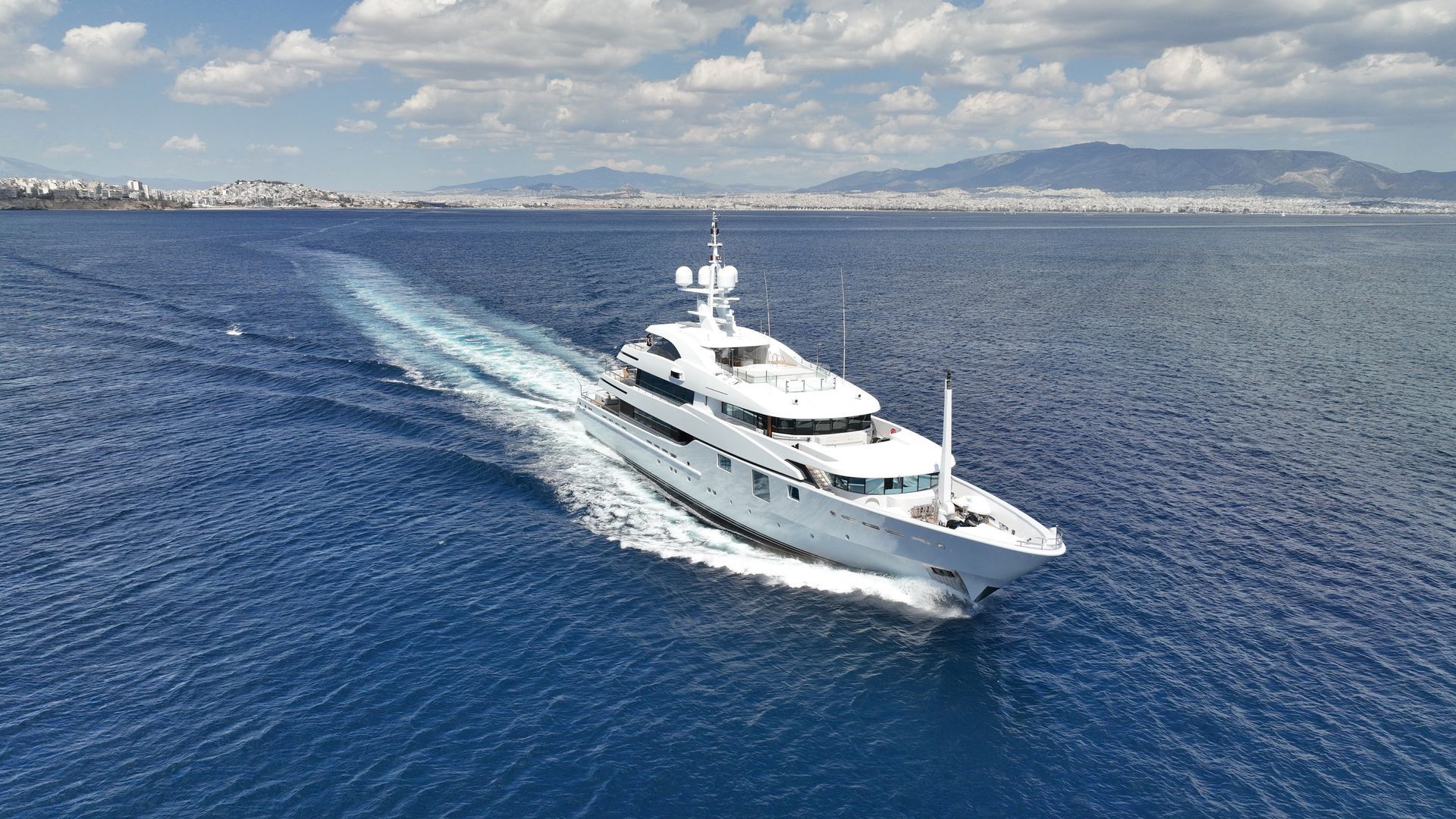 large 50m modern white superyacht sails the French Riviera at 15 knots