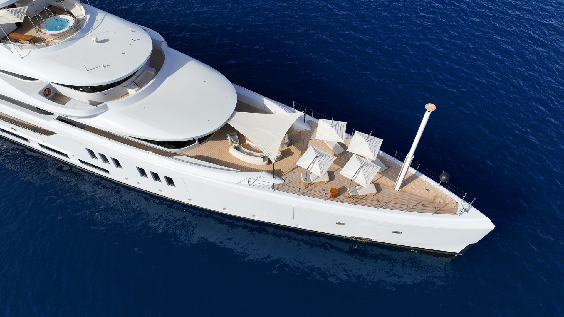 large white superyacht on a dead calm sea at Mykonos