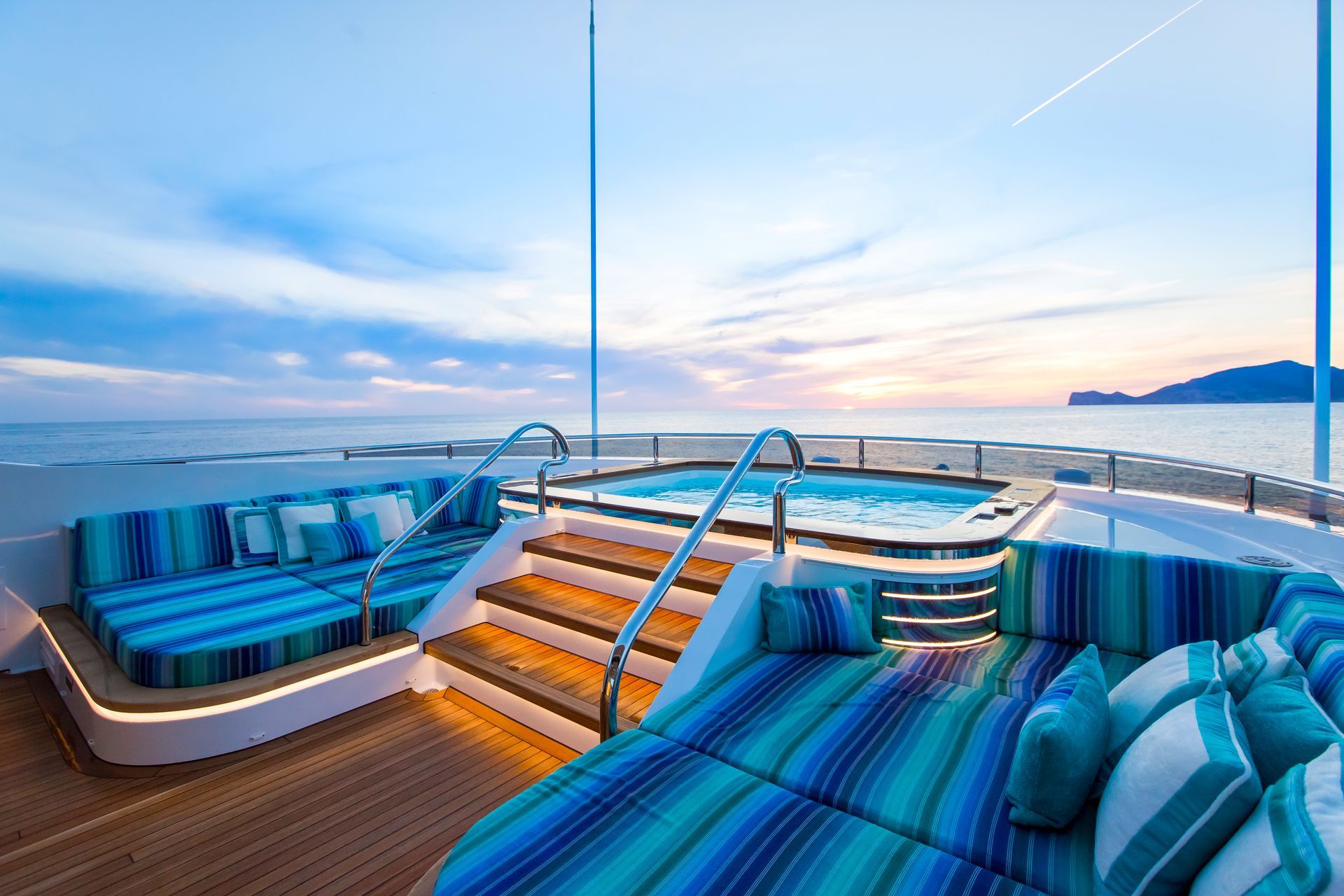 spa pool on upper sundeck on large superyacht surrounded by comfortable blue seating