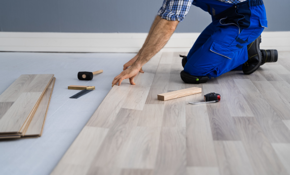 man installing flooring
