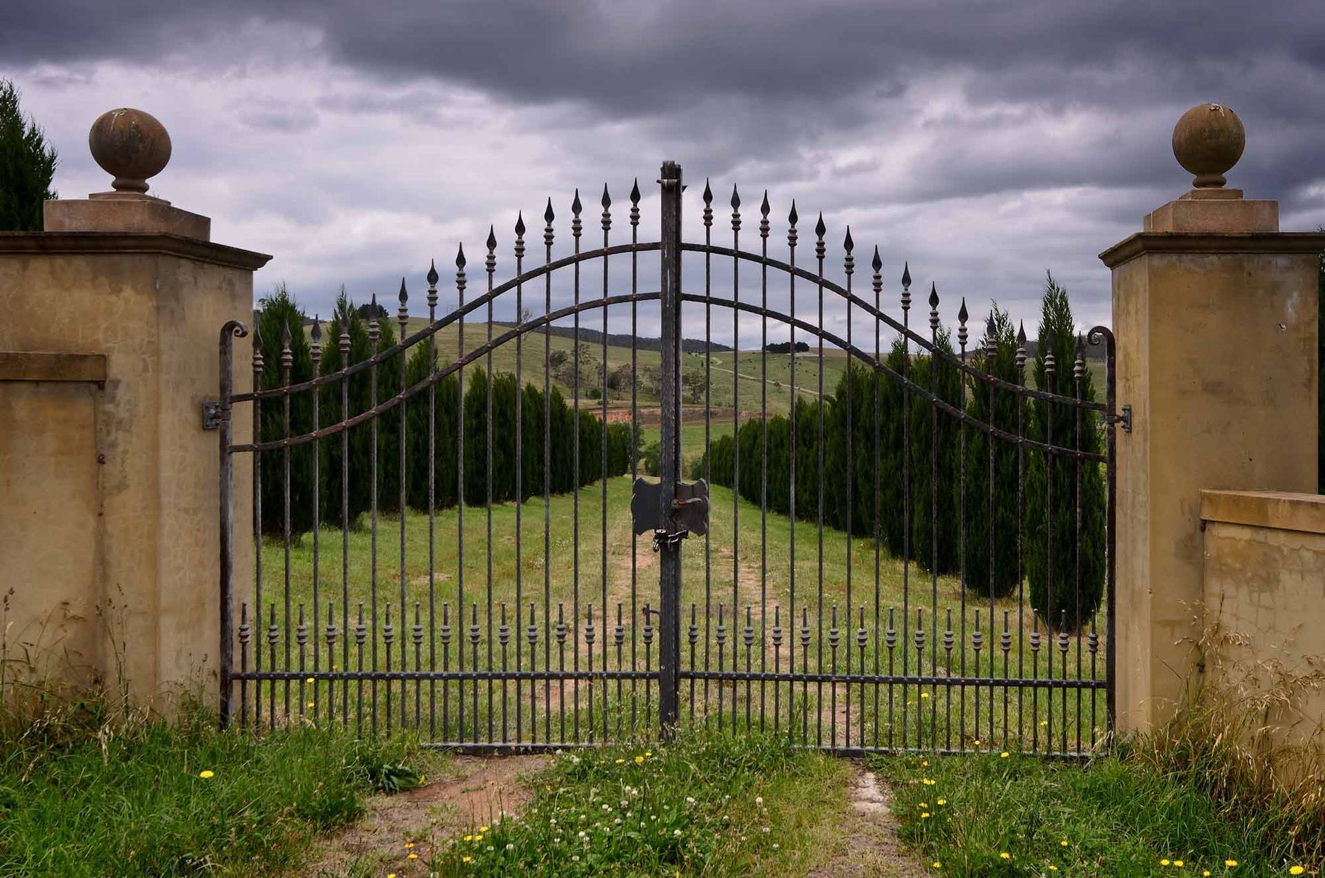 An Iron Gate Leading to A Field of Trees | Cranbourne, VIC | Cranbourne Fencing Pty Ltd