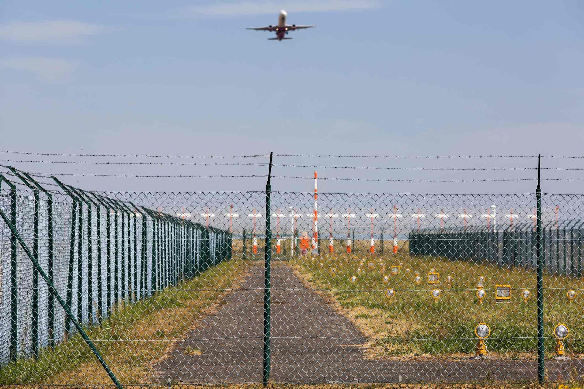 A Plane Is Taking Off from An Airport Runway Behind a Barbed Wire Fence | Cranbourne, VIC | Cranbourne Fencing Pty Ltd