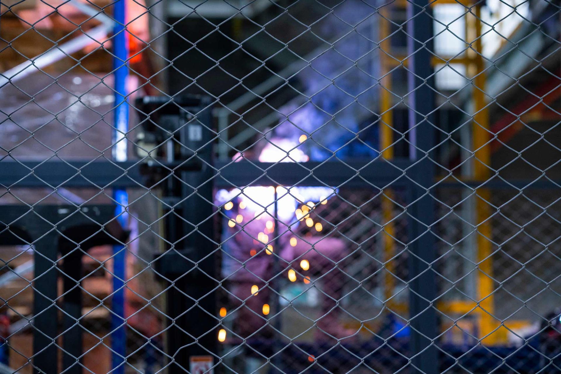 A Blurred Image of A Warehouse Through a Chain Link Fence | Cranbourne, VIC | Cranbourne Fencing Pty Ltd