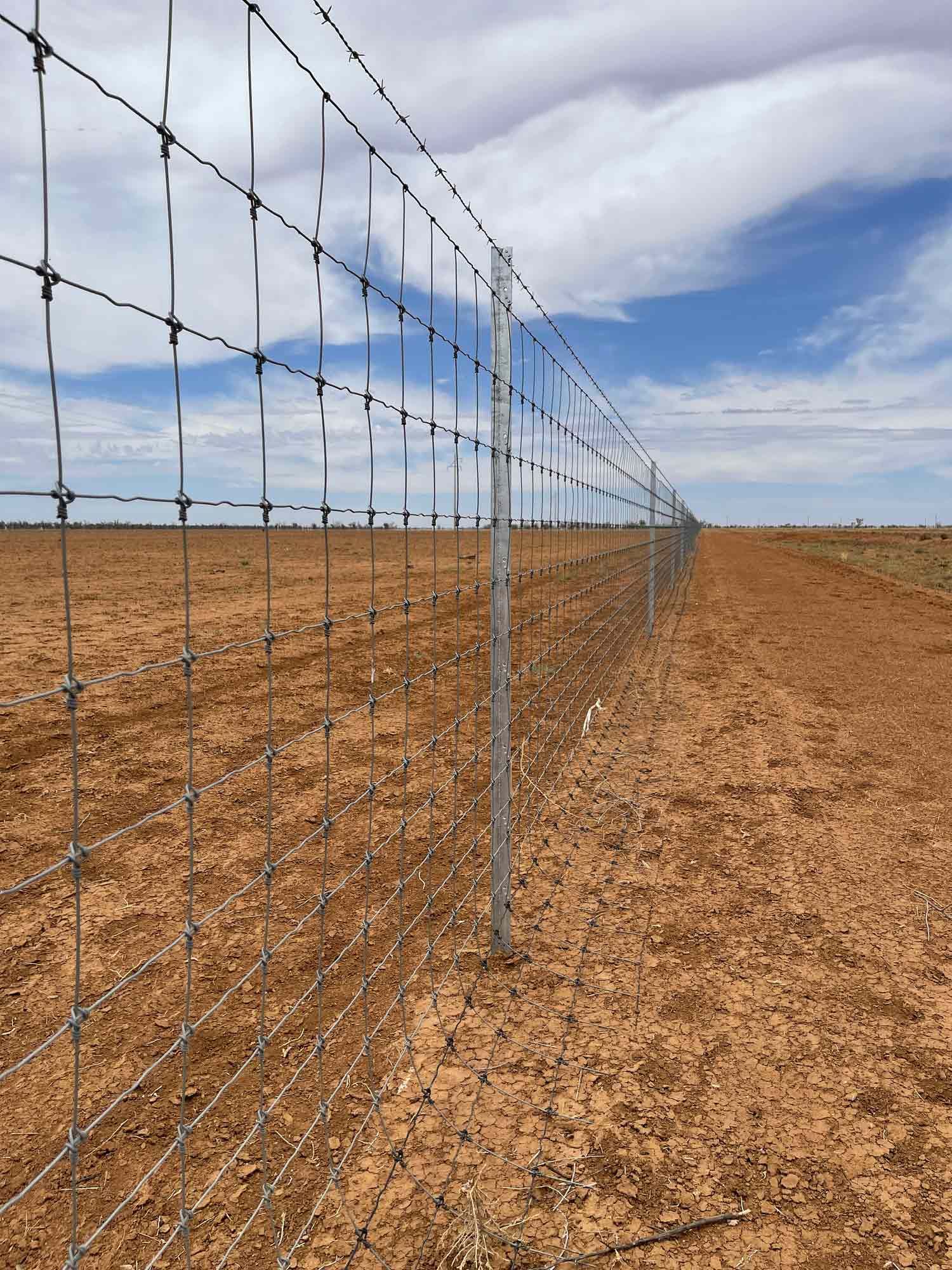 A Barbed Wire Fence Surrounds a Dirt Field | Cranbourne, VIC | Cranbourne Fencing Pty Ltd